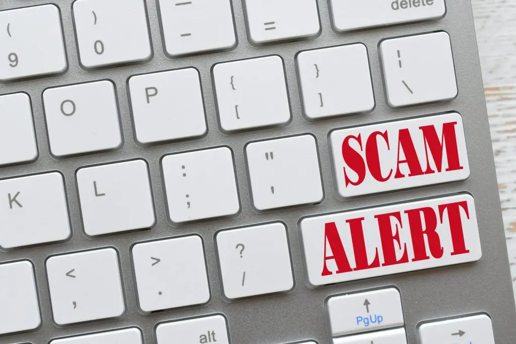 Computer keyboard displaying a prominent "SCAM ALERT" message, illustrating cybersecurity threats and endpoint protection services