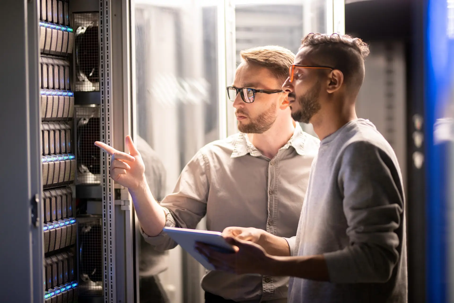 ITGuru Canada Inc technicians inspecting server hardware in a server room, addressing technology challenges and